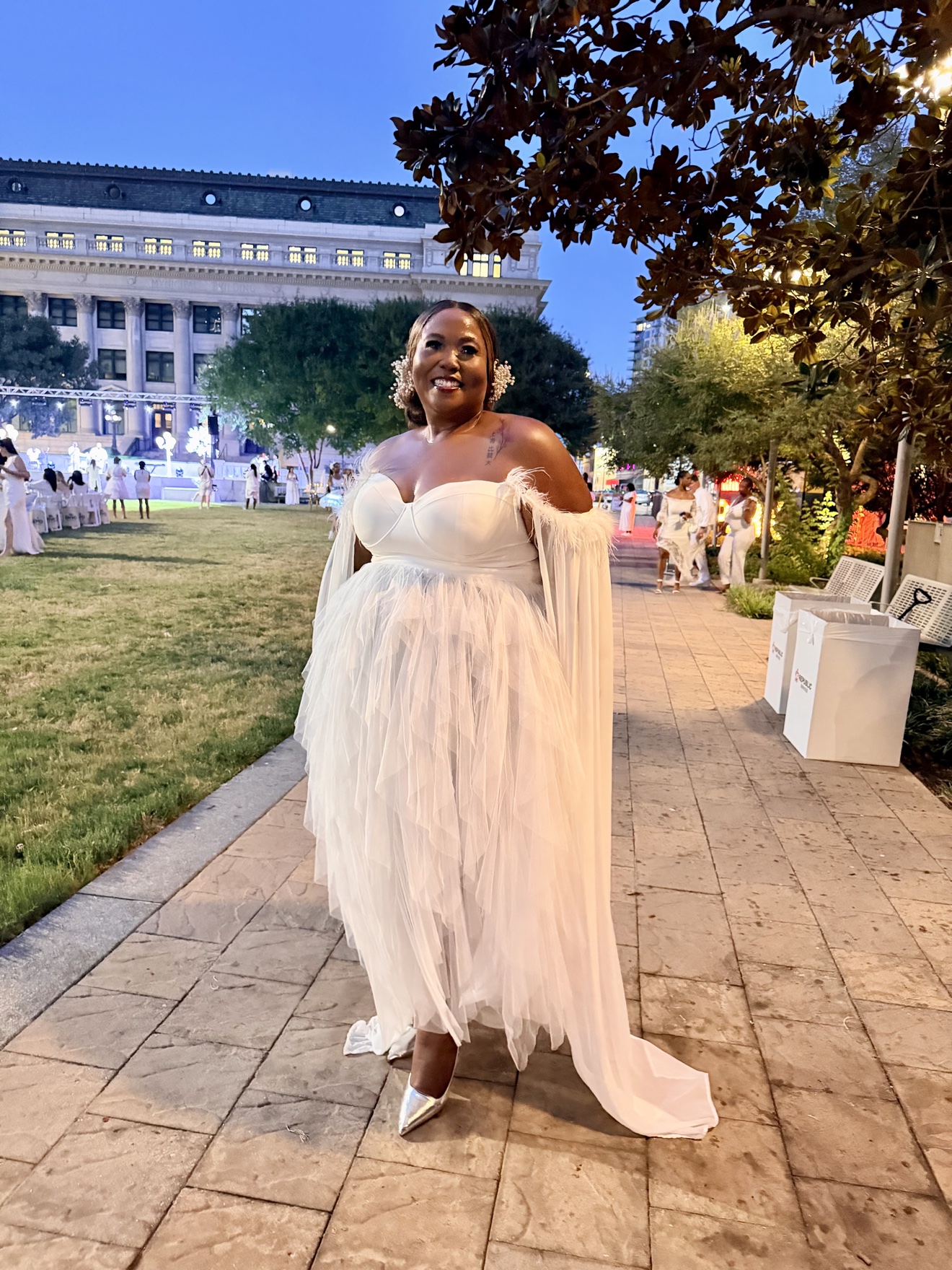 Trevilia Hodge wearing an elegant white gown at an outdoor evening event